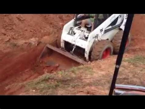 how deep can you dig with a skid steer|deep hole drilling skid steer.